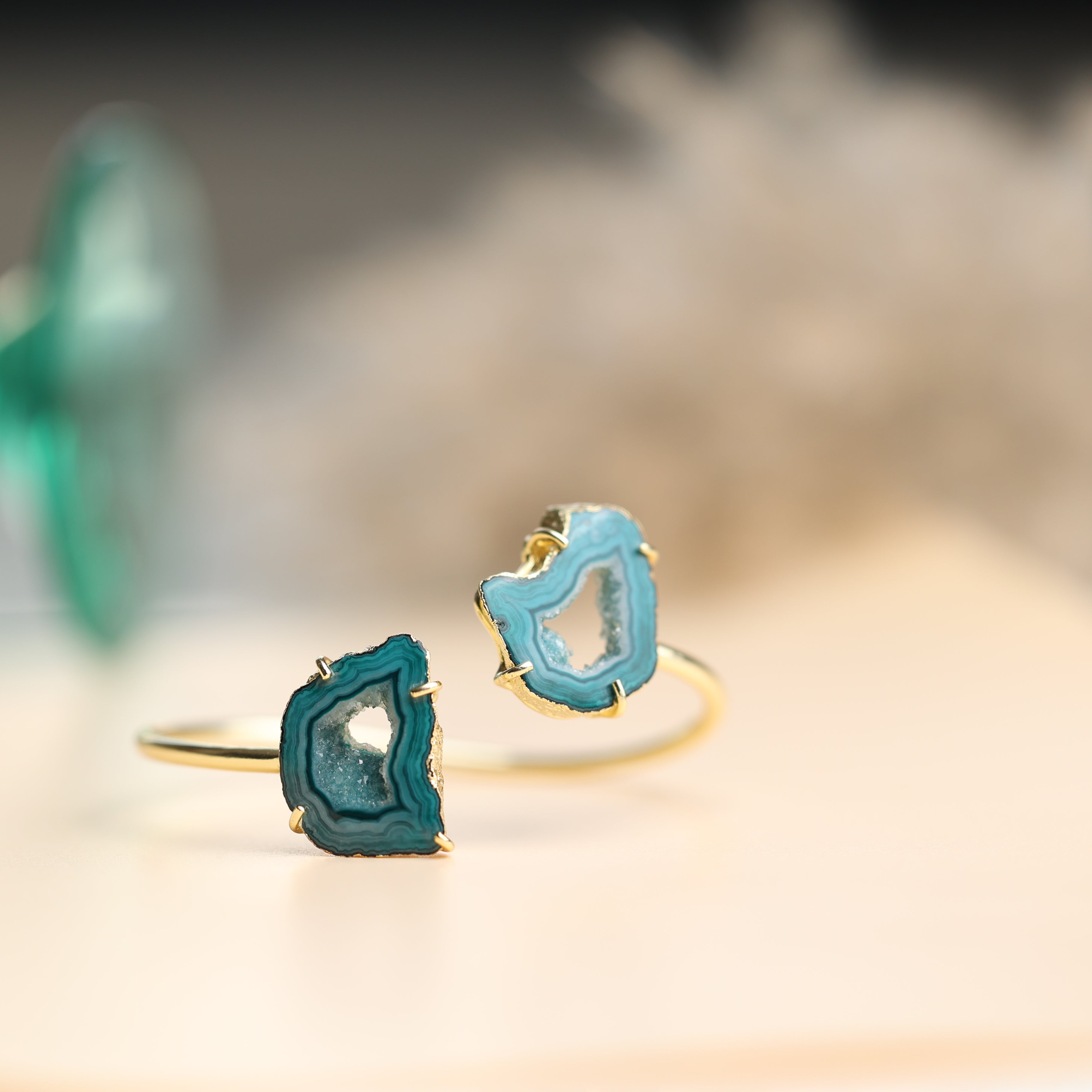 Two-stone agate slice bracelet with gold-edged detailing on an adjustable brass band